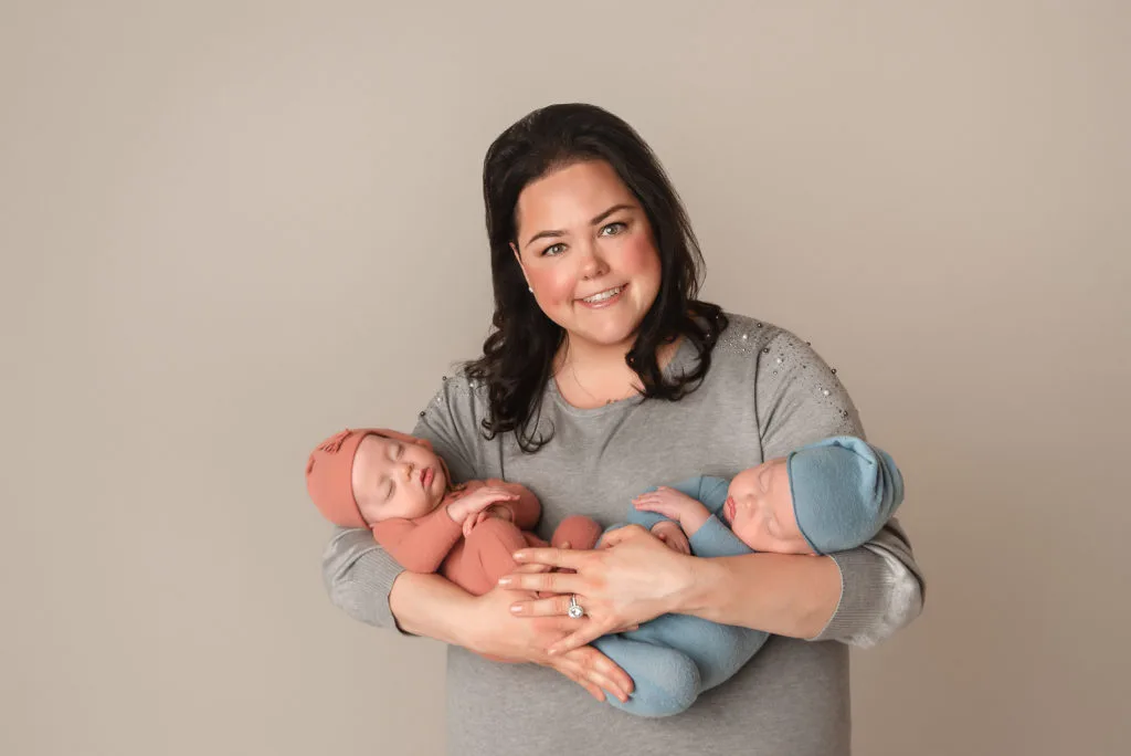 mom holds twins during Las Vegas Studio newborn portraits